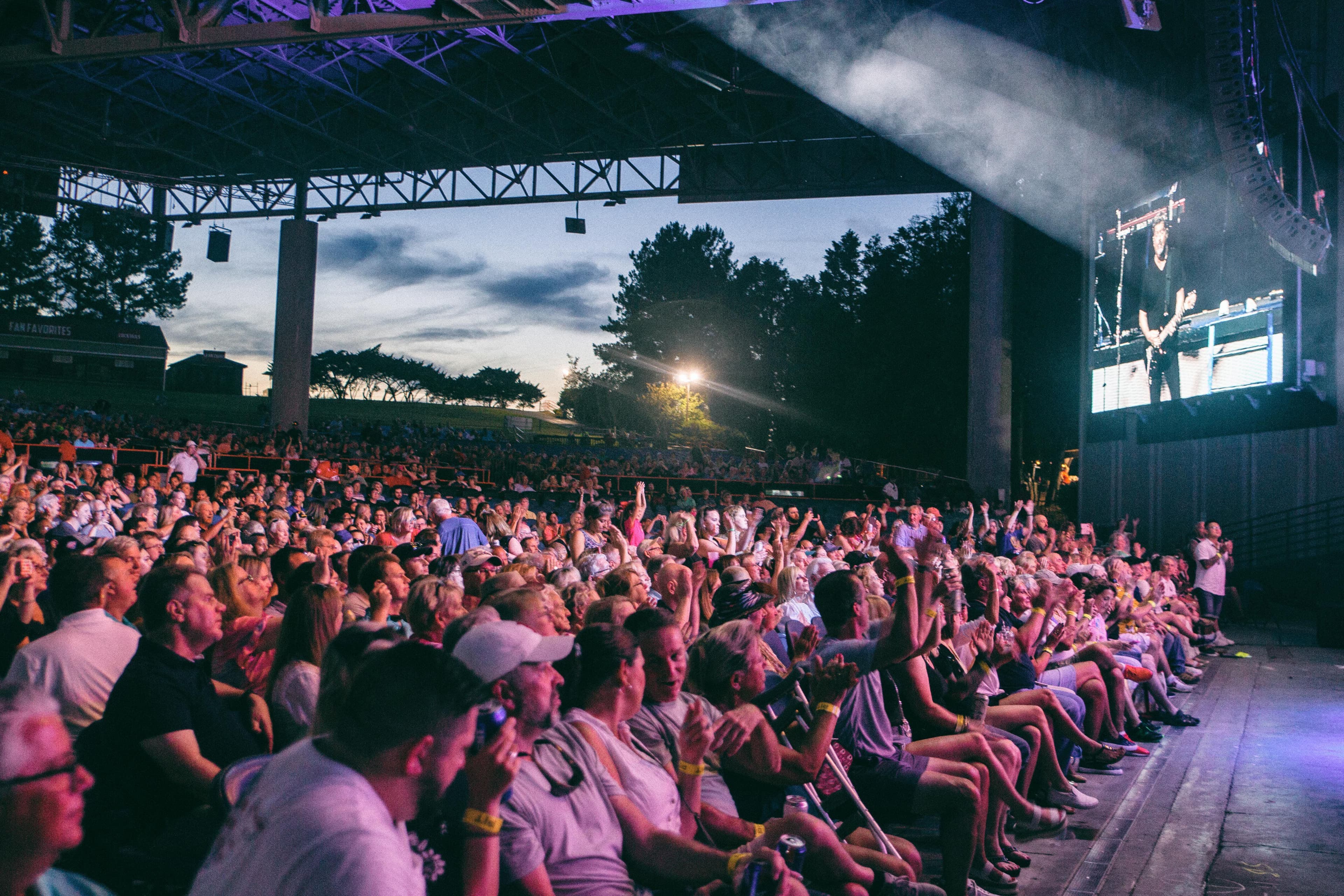 Concert crowd at a Charlotte amphitheater show — party bus concert transportation by Prestige Worldwide