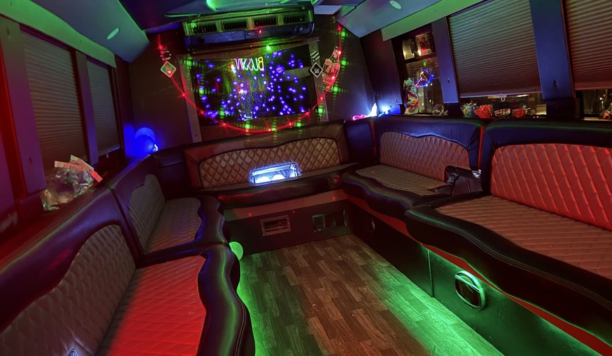 Prestige Worldwide Charlotte party bus at night with LED lounge lighting