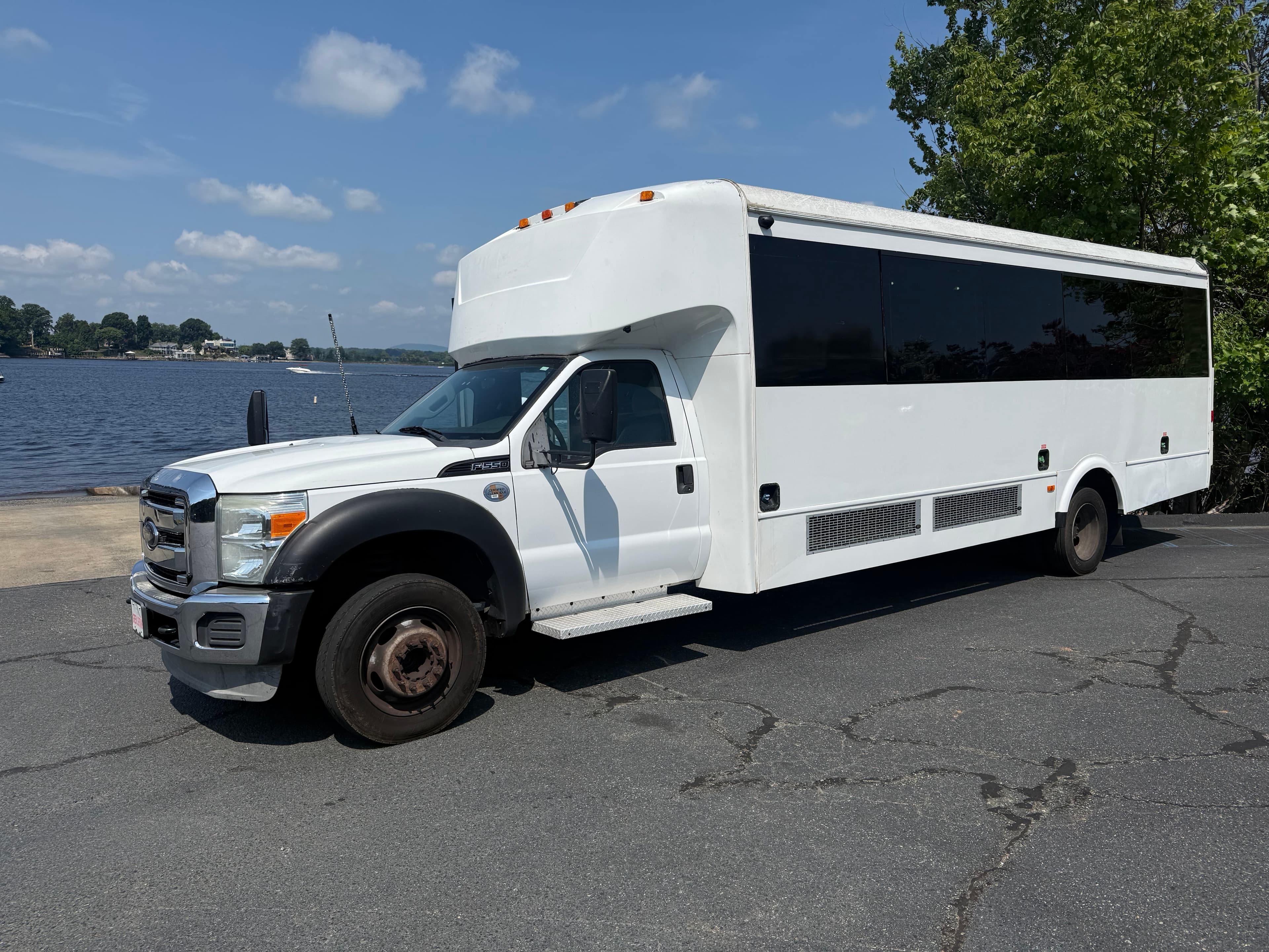 Prestige party bus parked lakeside at Lake Norman for Carolina Tiki boat charters
