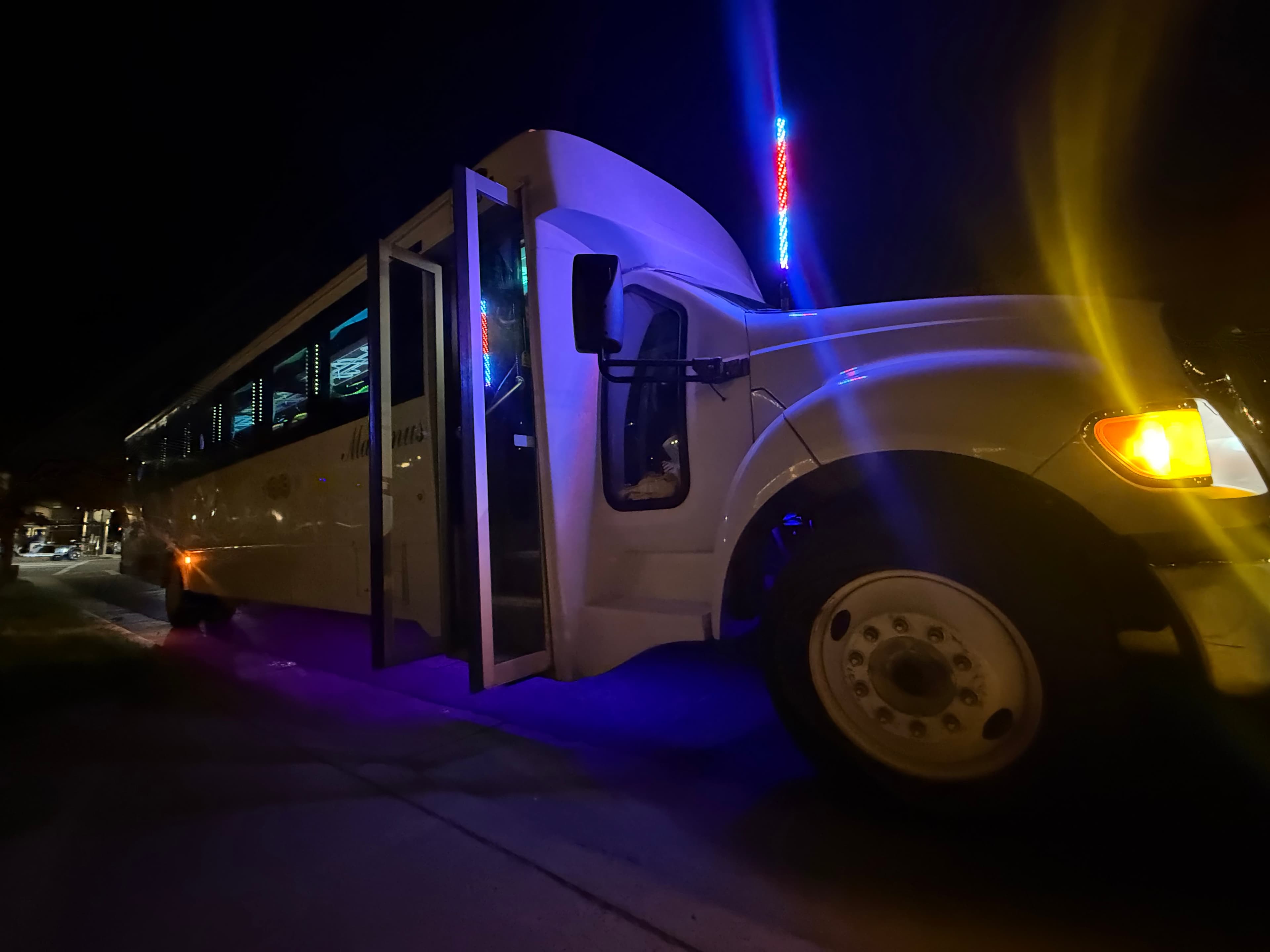 The Brennan 30 passenger LGE party bus at night with LED lighting in Charlotte NC
