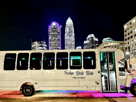 Charlotte city tours in a luxury party bus near the skyline at night