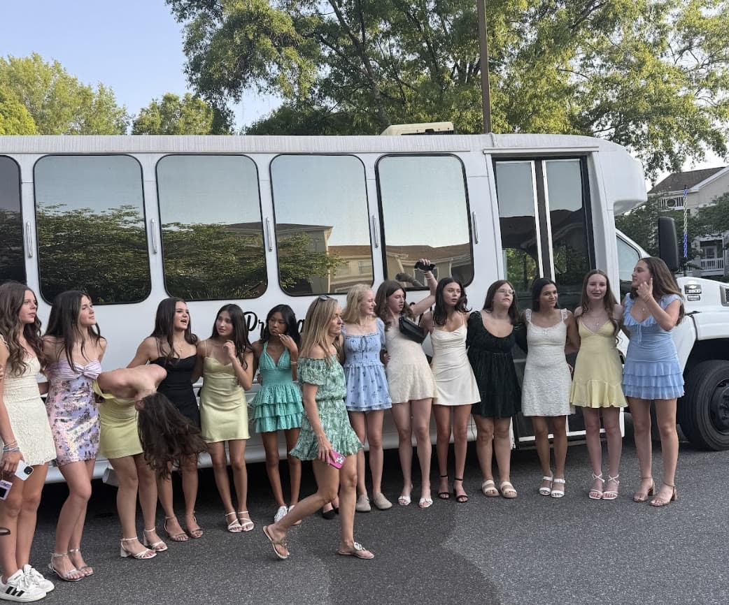 Charlotte prom group arriving in a Prestige Worldwide party bus at night